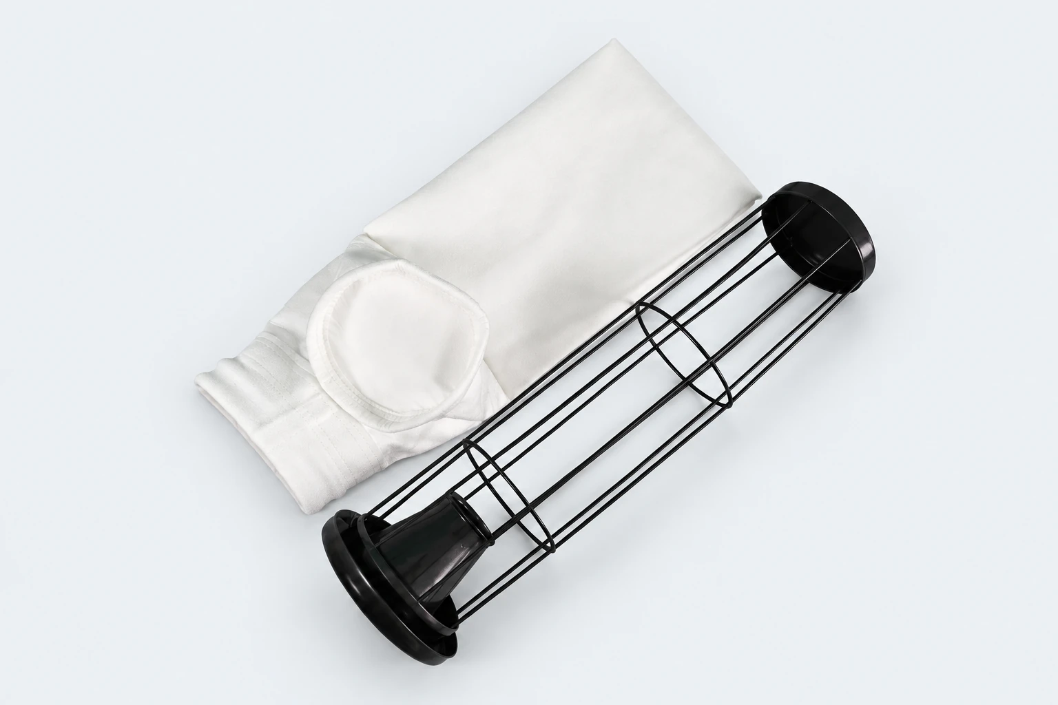 Finished dust collector filter bag beside a support cage